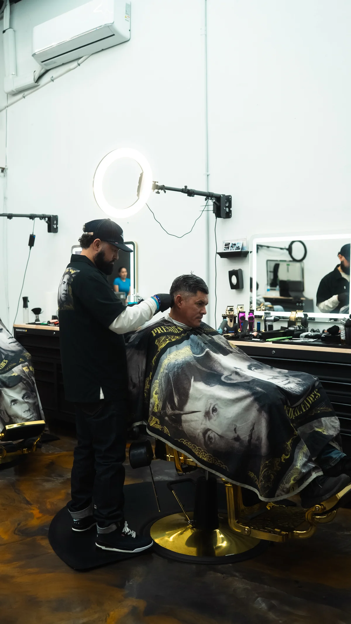 Julio styling a classic cut at Presidential Fades